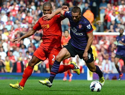 Lukas Podolski (right) vies with Liverpool's Glen Johnson